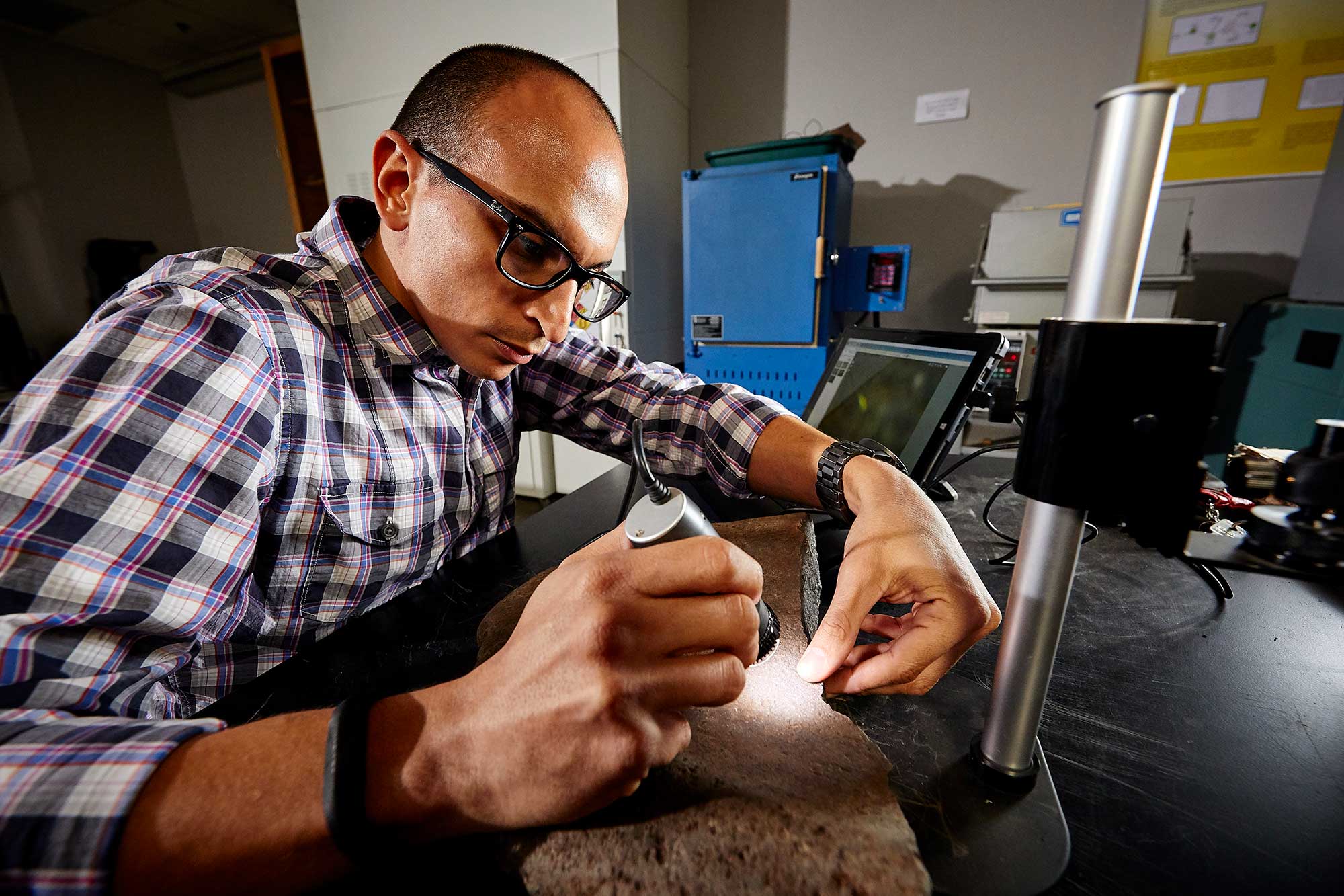 A person inspects a fossil