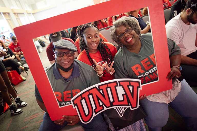 Students pose in U-N-L-V frame