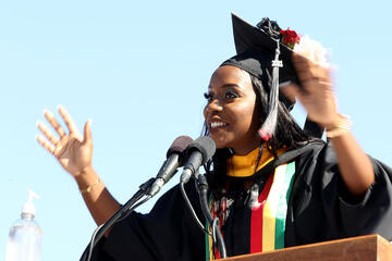 smiling graduate on podium