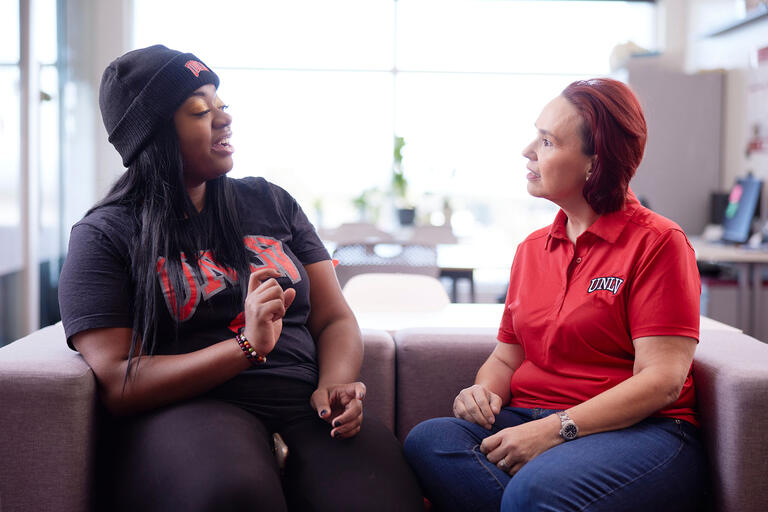 two people talking on an office couch