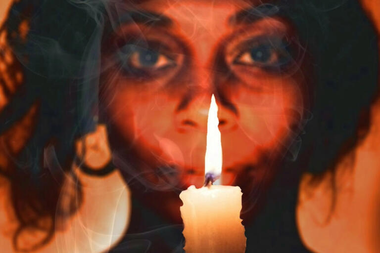A woman holding a candle.