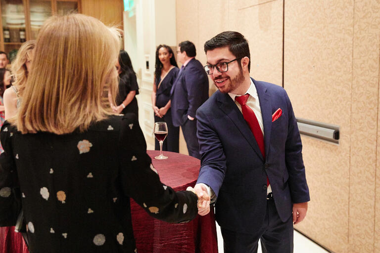 Two people shaking hands at a function.