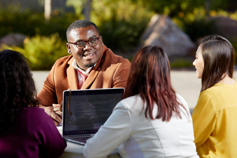 Graduate students study in a circle.