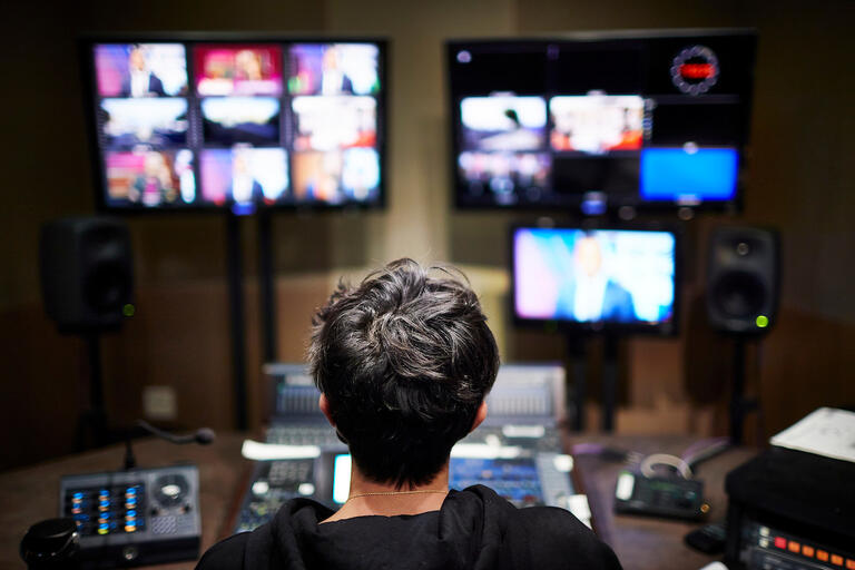 Person viewing monitors