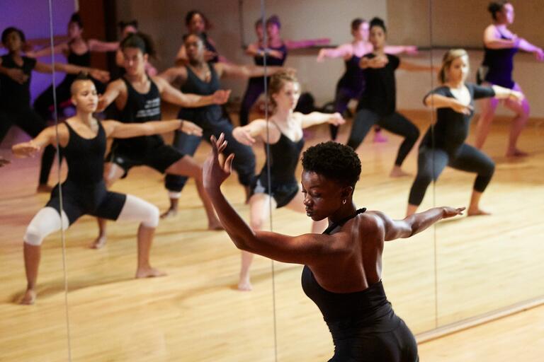 A dance teacher instructs class