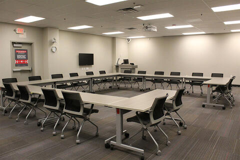 Multi-use room with a u-shaped table and chairs