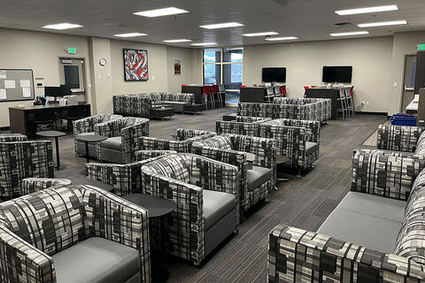 A lounge area with chairs and tables